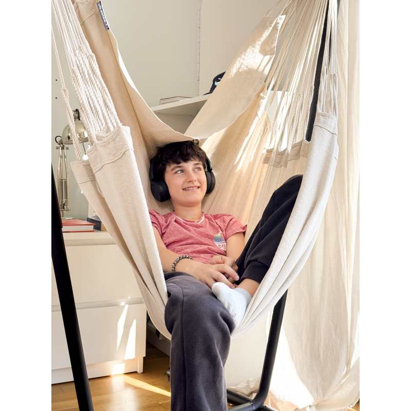 Fiji Organic Latte – Organic Cotton Comfort Size Hammock Chair with Galvanized Steel Stand – close view of a teen wearing headphones in the Latte hammock chair