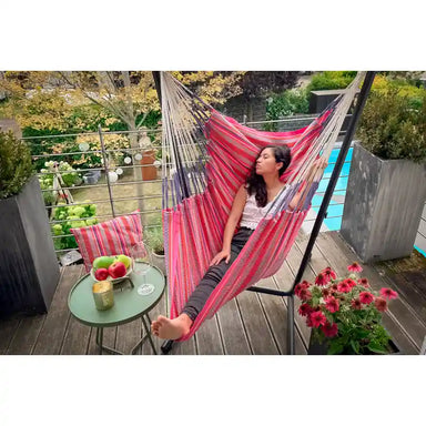 Fiji Organic Flamingo – Organic Cotton Comfort Size Hammock Chair with Galvanized Steel Stand – person resting on a balcony