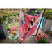 Fiji Organic Flamingo – Organic Cotton Comfort Size Hammock Chair with Galvanized Steel Stand – person resting on a balcony