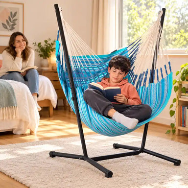 Fiji Organic Azure – Organic Cotton Comfort Size Hammock Chair with Galvanized Steel Stand – lifestyle illustration of tween reading in a family bedroom with an adult nearby