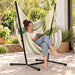 Fiji Outdoor Cedar – Weather-Resistant Comfort Size Hammock Chair with Galvanized Steel Stand – lifestyle illustration of adult reading in the hammock chair on a patio