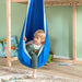 LA SIESTA Joki Dolphy Kids Hanging Nest – kid seated in a playroom hanging nest