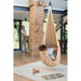LA SIESTA Joki Teddy Kids Hanging Nest – kid reclining beside a brick column