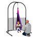 LA SIESTA Joki Lilly Kids Hanging Nest – kid seated with a ukulele in the Lilly nest on a separately sold Arcada stand with an adult nearby