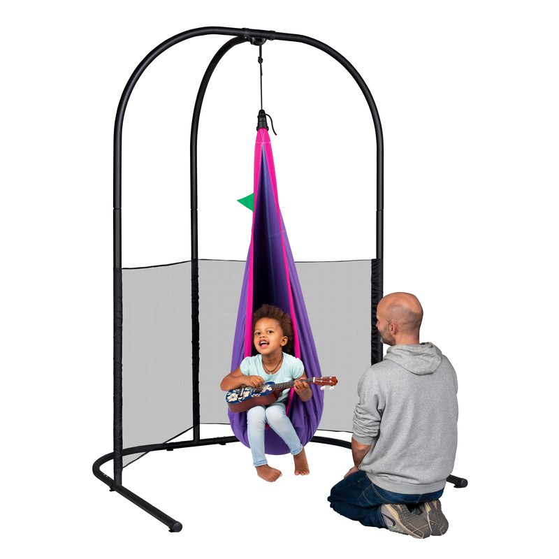 LA SIESTA Joki Lilly Kids Hanging Nest – kid seated with a ukulele in the Lilly nest on a separately sold Arcada stand with an adult nearby