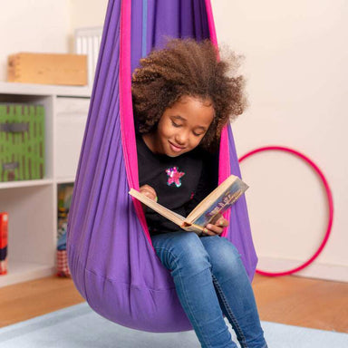 LA SIESTA Joki Lilly Kids Hanging Nest – kid reading in a pink and purple hanging nest