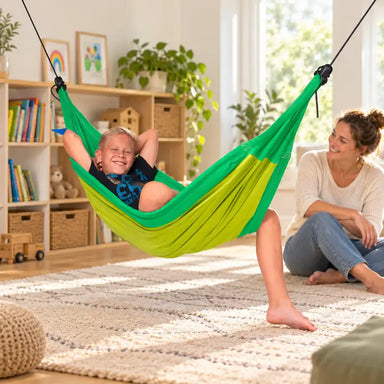 LA SIESTA Moki Froggy Kids Hammock with Suspension – lifestyle illustration of kid relaxing in a family reading corner with an adult nearby