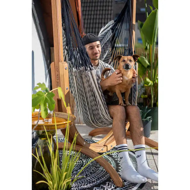Udine Organic Zebra - Organic Cotton Hammock Chair with FSC® certified Eucalyptus Stand – person seated with a dog