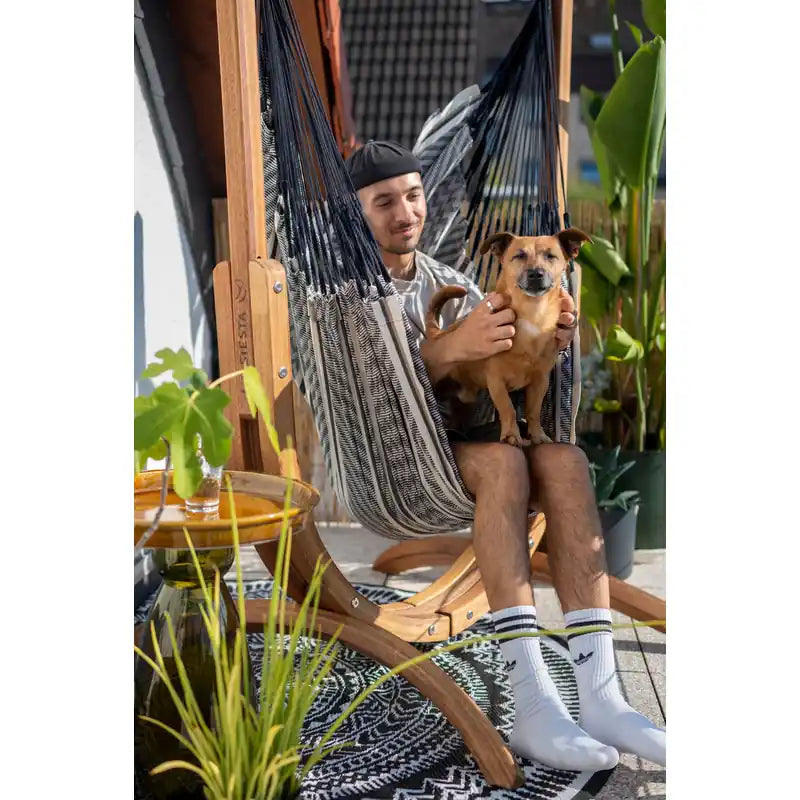 Udine Organic Zebra - Organic Cotton Hammock Chair with FSC® certified Eucalyptus Stand – person seated with a dog