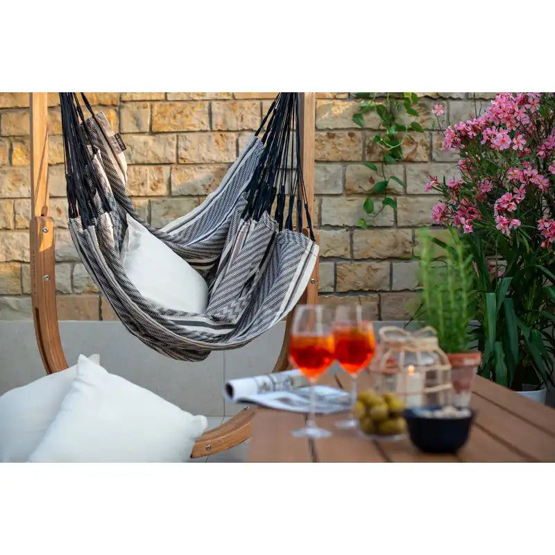 Udine Organic Zebra - Organic Cotton Hammock Chair with FSC® certified Eucalyptus Stand – zebra chair beside an outdoor table