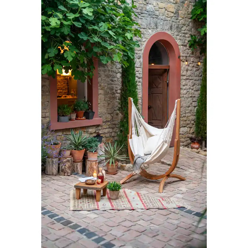 Udine Organic Latte - Organic Cotton Hammock Chair with FSC® certified Eucalyptus Stand – empty chair in a brick courtyard