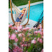 Udine Organic Latte - Organic Cotton Hammock Chair with FSC® certified Eucalyptus Stand – seated user beside a pool