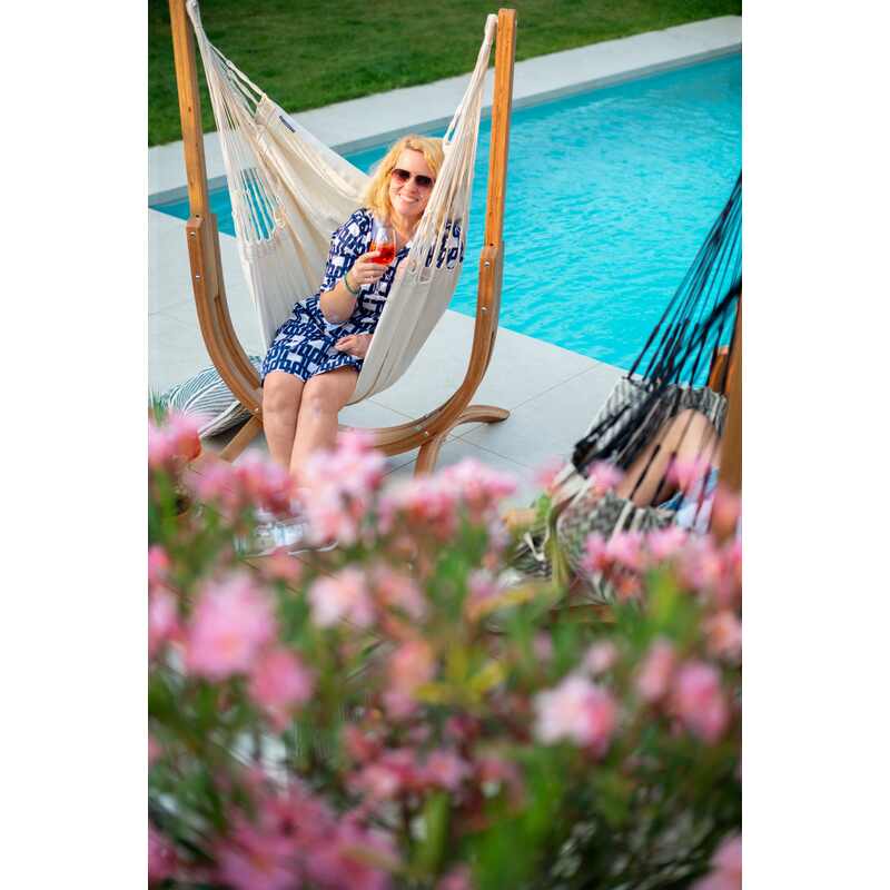 Udine Organic Latte - Organic Cotton Hammock Chair with FSC® certified Eucalyptus Stand – seated user beside a pool