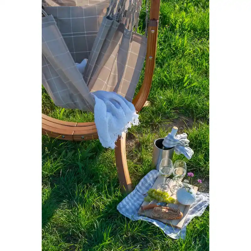 Udine Outdoor Almond - Weather-Resistant Hammock Chair with FSC® certified Eucalyptus Stand – chair beside an outdoor picnic