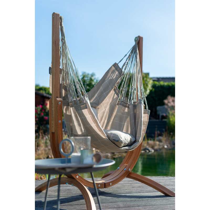 Udine Outdoor Almond - Weather-Resistant Hammock Chair with FSC® certified Eucalyptus Stand – chair beside an outdoor table