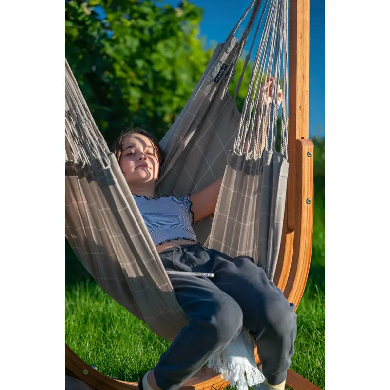 Udine Outdoor Almond - Weather-Resistant Hammock Chair with FSC® certified Eucalyptus Stand – close view of a reclining person