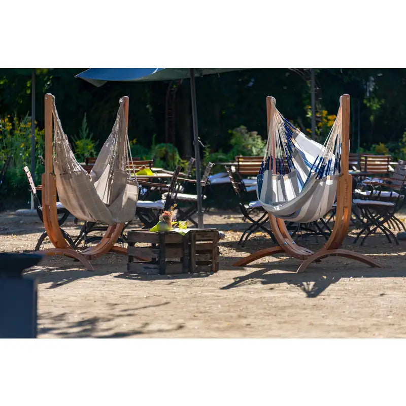 Udine Outdoor Almond - Weather-Resistant Hammock Chair with FSC® certified Eucalyptus Stand – several chairs in a courtyard