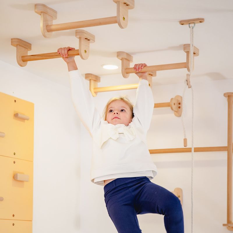 Monkey Bars Kit – kid gripping a ceiling bar with both hands