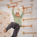 Monkey Bars Kit – kid using ceiling bars beside wall bars