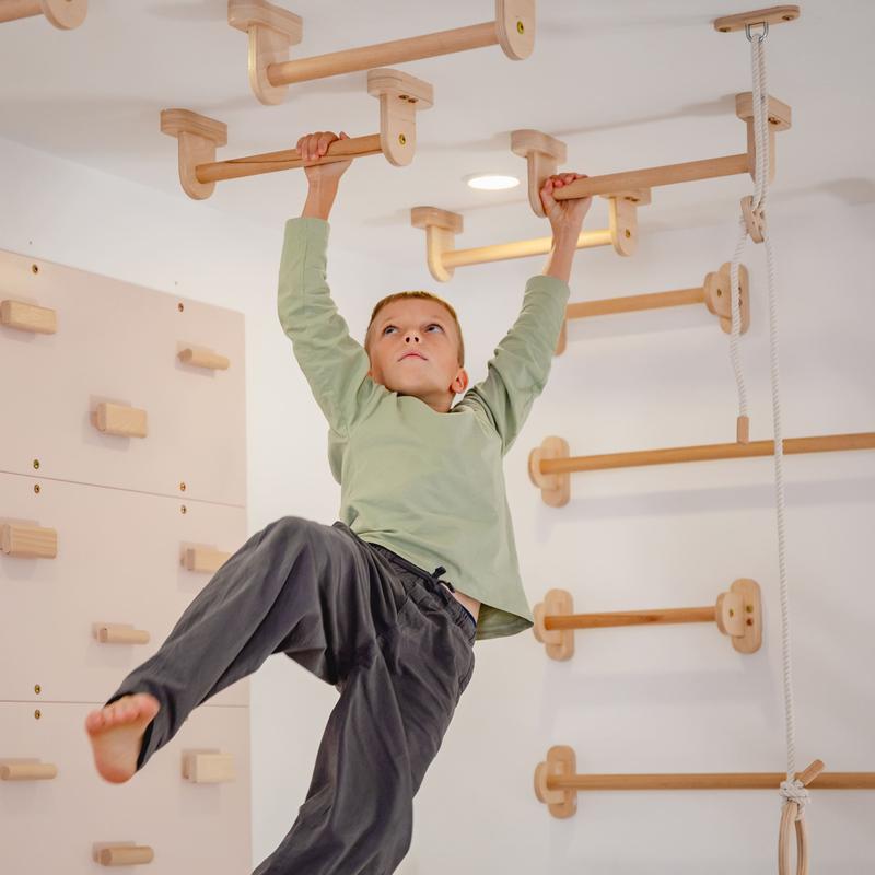 Monkey Bars Kit – kid using ceiling bars beside wall bars
