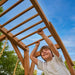 monkey bars on wooden swing set hawthorn xl with boy playing