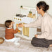 Mother and Child Opening the Cabinet of Tiny Land Honey Kitchenett Pretend Play