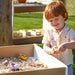 outdoorEd Big and white table with a boy playing