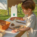 Market stand with kid playing outside
