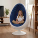 Oval Serenity Pod - Blue - child sitting in the blue cushioned pod in a living room