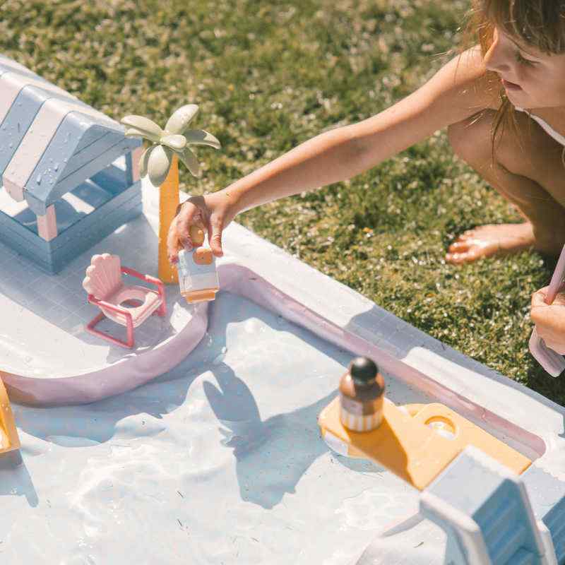 Smol Pool Day Water Table poolside shack with chairs, loungers, and play accessories