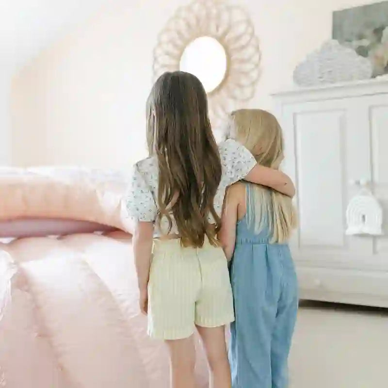 Kids playing on the Smol Rainbow Pink Bounce House