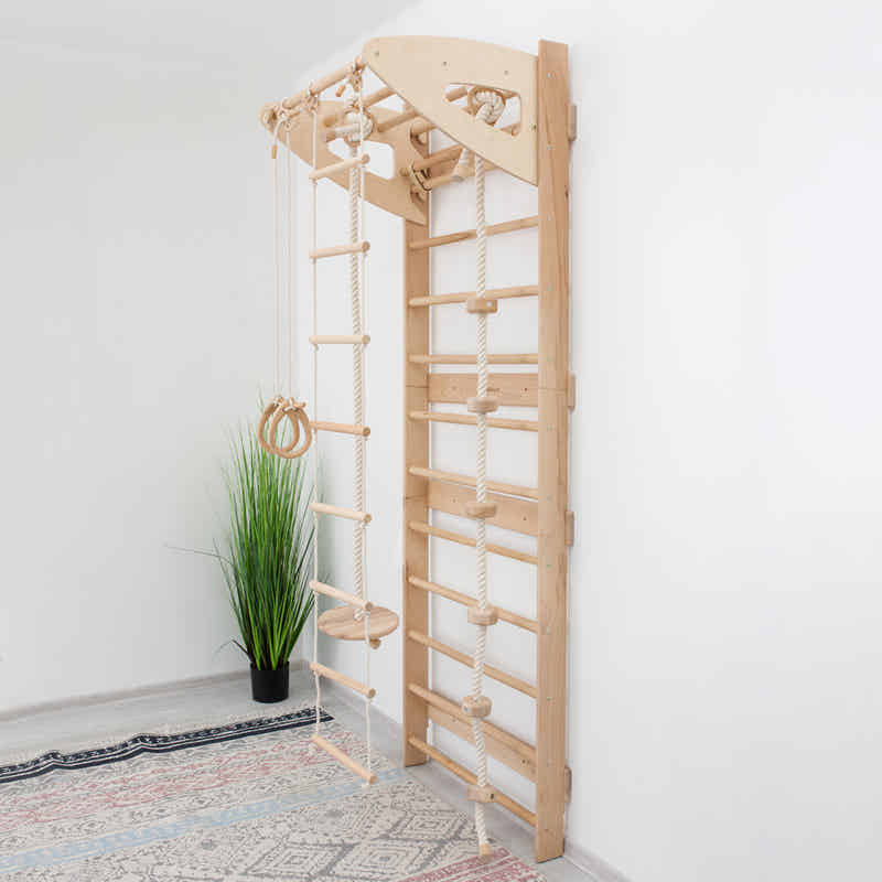 Swedish Wall Gym Set with Accessories – angled view of the natural wood wall ladder