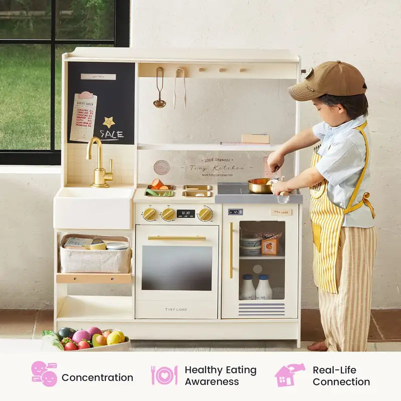 Tiny Land® BistroSwitch Play Kitchen – Child in apron pretending to cook at the Cream kitchen