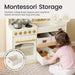 Tiny Land® Wooden Play Kitchen with Storage for Creative Toddlers – Child sorting a storage bin beside the Cream kitchen