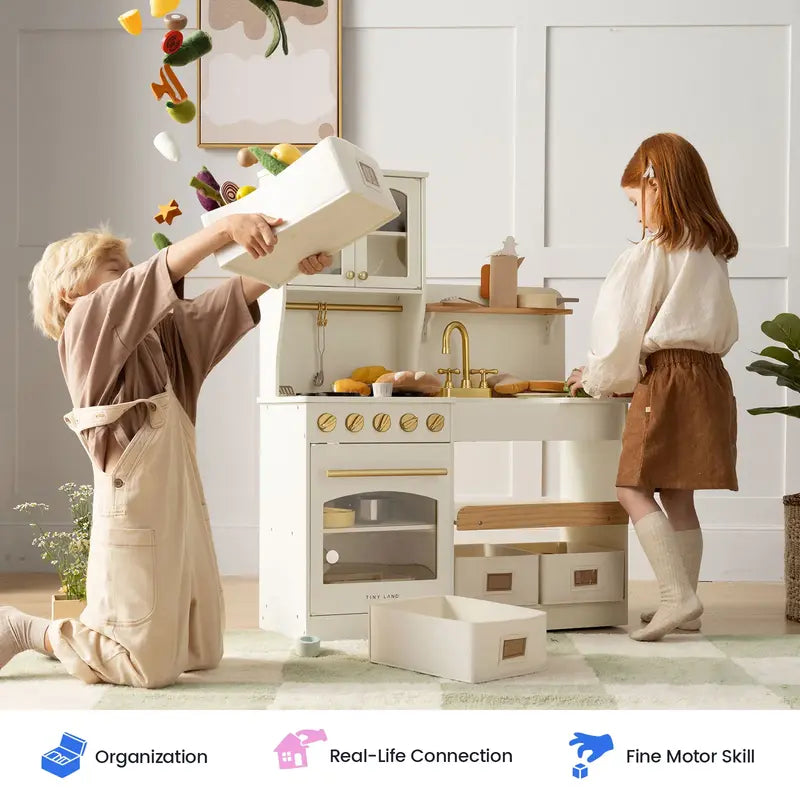 Tiny Land® Wooden Play Kitchen with Storage for Creative Toddlers – Two children sorting play food and bins beside the Cream kitchen