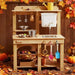 Tiny Land® Mud Kitchen - DuoPlay Outdoor Play Kitchen for Kids – child using outdoor mud kitchen