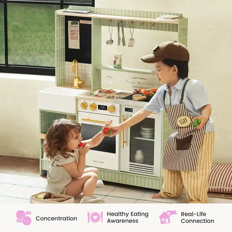 Tiny Land® BistroSwitch Play Kitchen – Two children sharing pretend food beside the Green kitchen