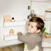 Tiny Land® Play Kitchen Accessories – Play Kitchen Fridge: Wooden Cabinet Refrigerator for Kids – Child placing toy eggs in an inside-door storage bin