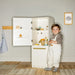 Tiny Land® Play Kitchen Accessories – Play Kitchen Fridge: Wooden Cabinet Refrigerator for Kids – Child beside open play fridge with staged play food