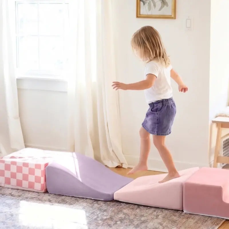 Tiny Land® PlayNest Climbing Blocks - Violet – child stepping across a row of Violet foam ramps and blocks