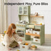 Tiny Land® Wooden Play Kitchen with Storage for Creative Toddlers – Child sitting beside Sage kitchen with a removable storage bin
