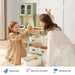 Tiny Land® Wooden Play Kitchen with Storage for Creative Toddlers – Parent and child sharing pretend food beside the Sage kitchen