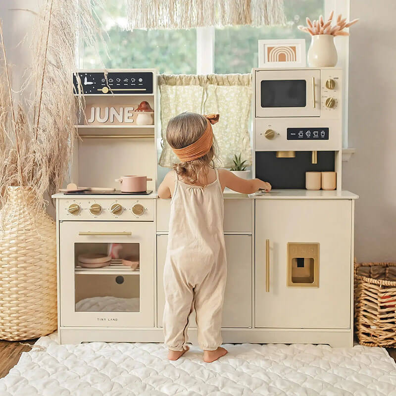 tiny_land_iconic_kitchen_cream_front_view_toddler_playing