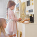 tiny_land_iconic_kitchen_cream_side_view_girls_playing