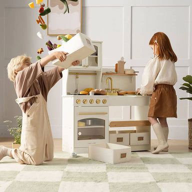 tiny land play kitchen in cream with kids playing