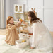 tiny land play kitchen in cream with girl and mom playing