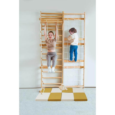Wooden Climbing Wall With an Avenlur Play Area  Floor Mat with a mom and child