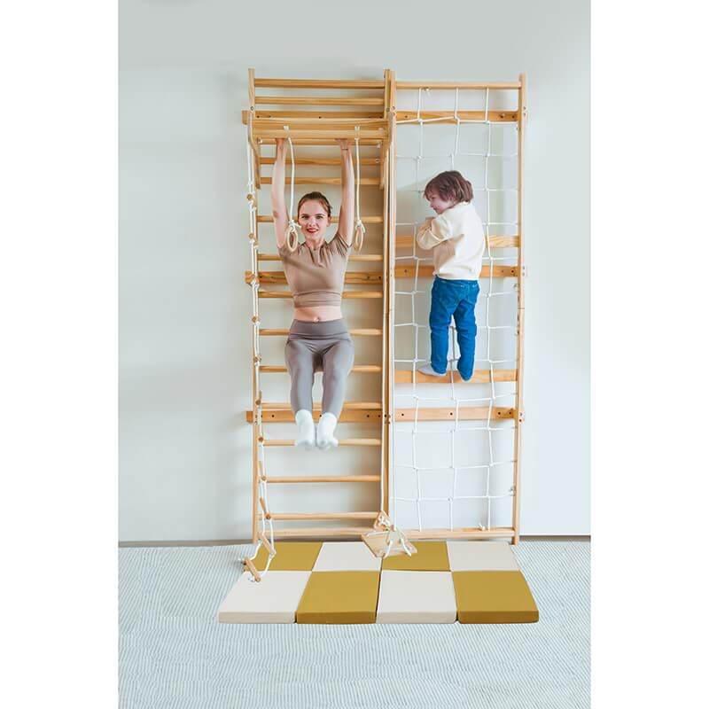 Wooden Climbing Wall With an Avenlur Play Area  Floor Mat with a mom and child