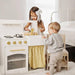 Two Children Playing Tiny Land Honey Kitchenett Playset Faucet