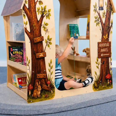 Treehouse Reading Nook - WB1531 – kid seated inside reaching toward a book on an interior shelf